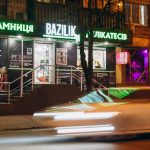 cars parked in front of store during night time