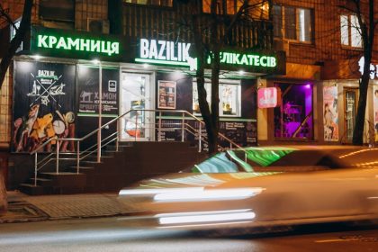 cars parked in front of store during night time