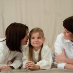Three generations of women smiling together, symbolizing familial love and connection.