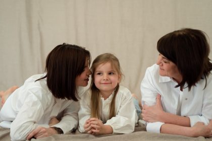 Three generations of women smiling together, symbolizing familial love and connection.