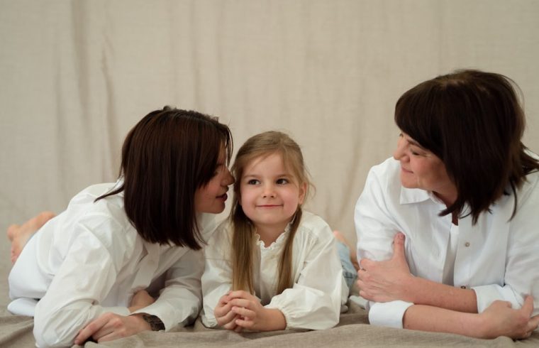 Three generations of women smiling together, symbolizing familial love and connection.