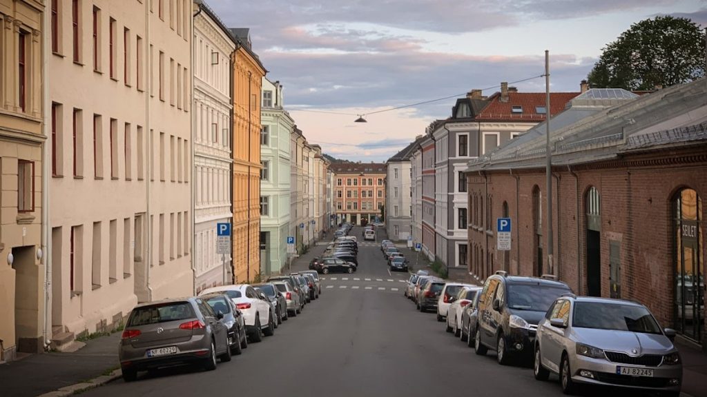 A street with the old houses and the parked cars in the Grünerløkka district of Oslo, Norway, August 2019