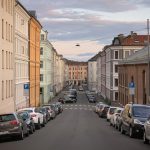 A street with the old houses and the parked cars in the Grünerløkka district of Oslo, Norway, August 2019