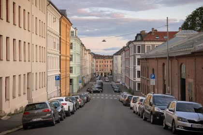 A street with the old houses and the parked cars in the Grünerløkka district of Oslo, Norway, August 2019