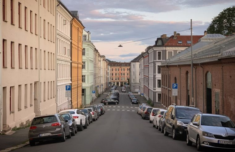 A street with the old houses and the parked cars in the Grünerløkka district of Oslo, Norway, August 2019